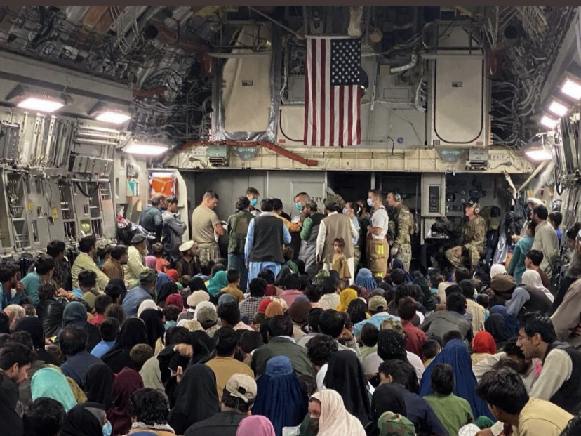 Crewmembers gather around the baby born aboard the Afghan evacuation flight. (USAF courtesy photo)