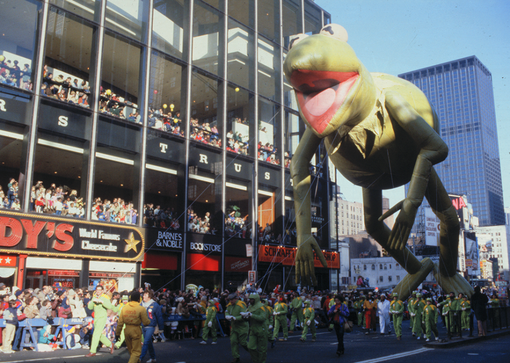 A giant inflatable balloon of Kermit the Frog makes its way down the parade route.